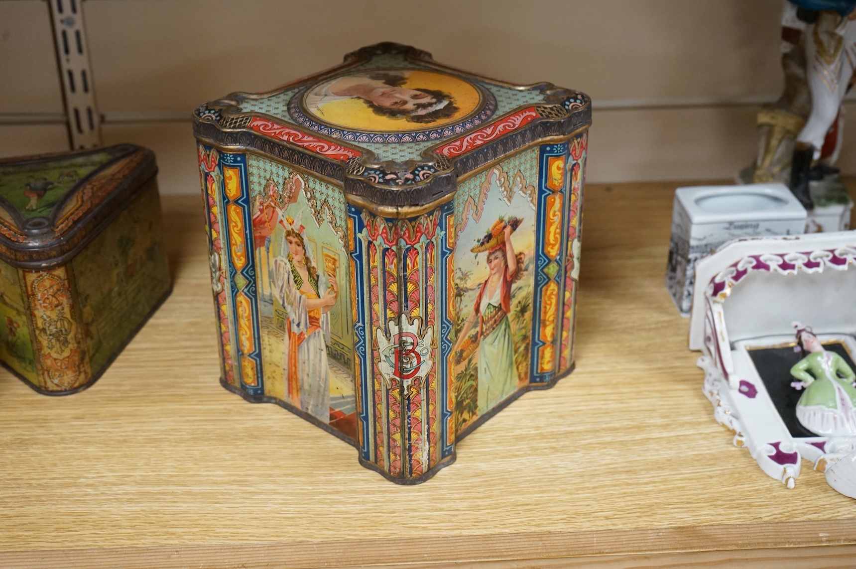 A Windmill biscuit tin by Huntley & Palmer: Reading & London, 'BIVM' Eastern Beauties tea tin and Huntley & Palmers triangular biscuit tin with 'Sports' motifs